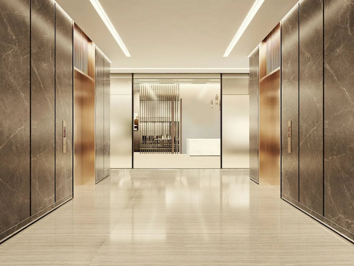 Modern lift lobby with marble walls and metal lift doors