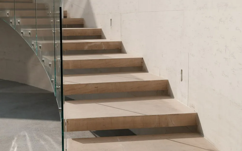 Stone staircase with a glass railing in bright sunlight