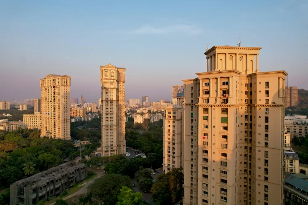 Residential apartment towers rising above greenery in an Indian city